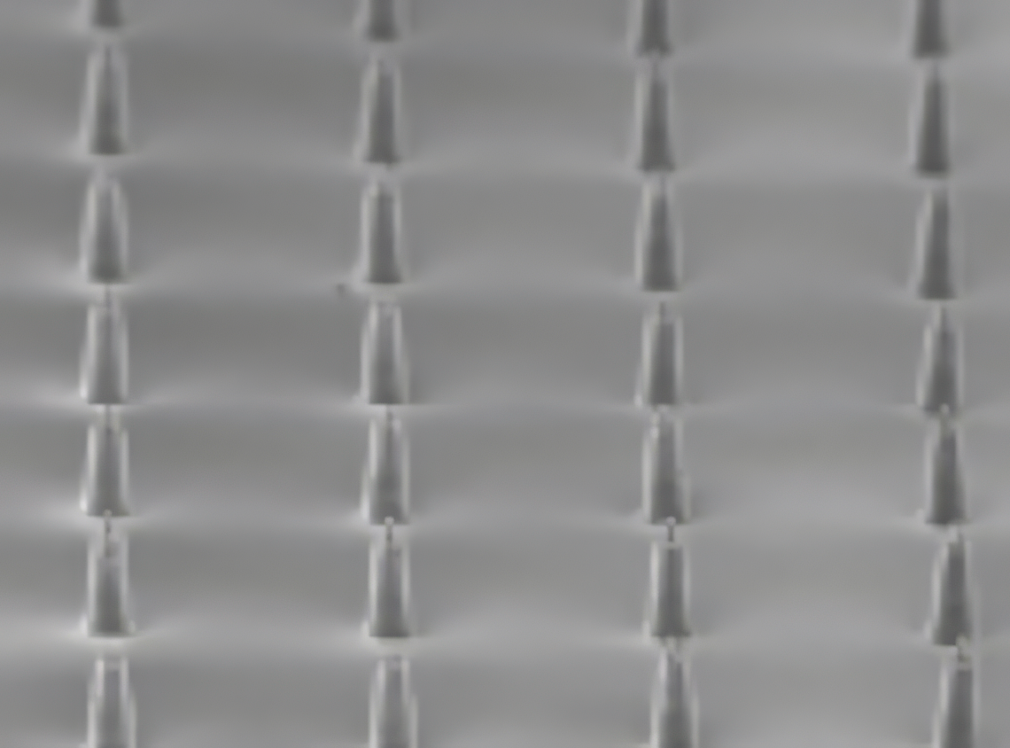 Microscope image of evenly spaced micro-needle structures across a surface